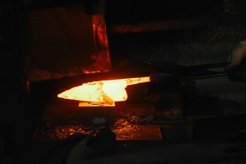 The knife begins to take shape during the forging process